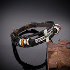 Pulsera de cuero trenzado negro con cruz e inscripción CONFIANZA EN DIOS