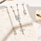 Pulsera con colgante de la Virgen y Crucifijo: Su Gracia en tu muñeca