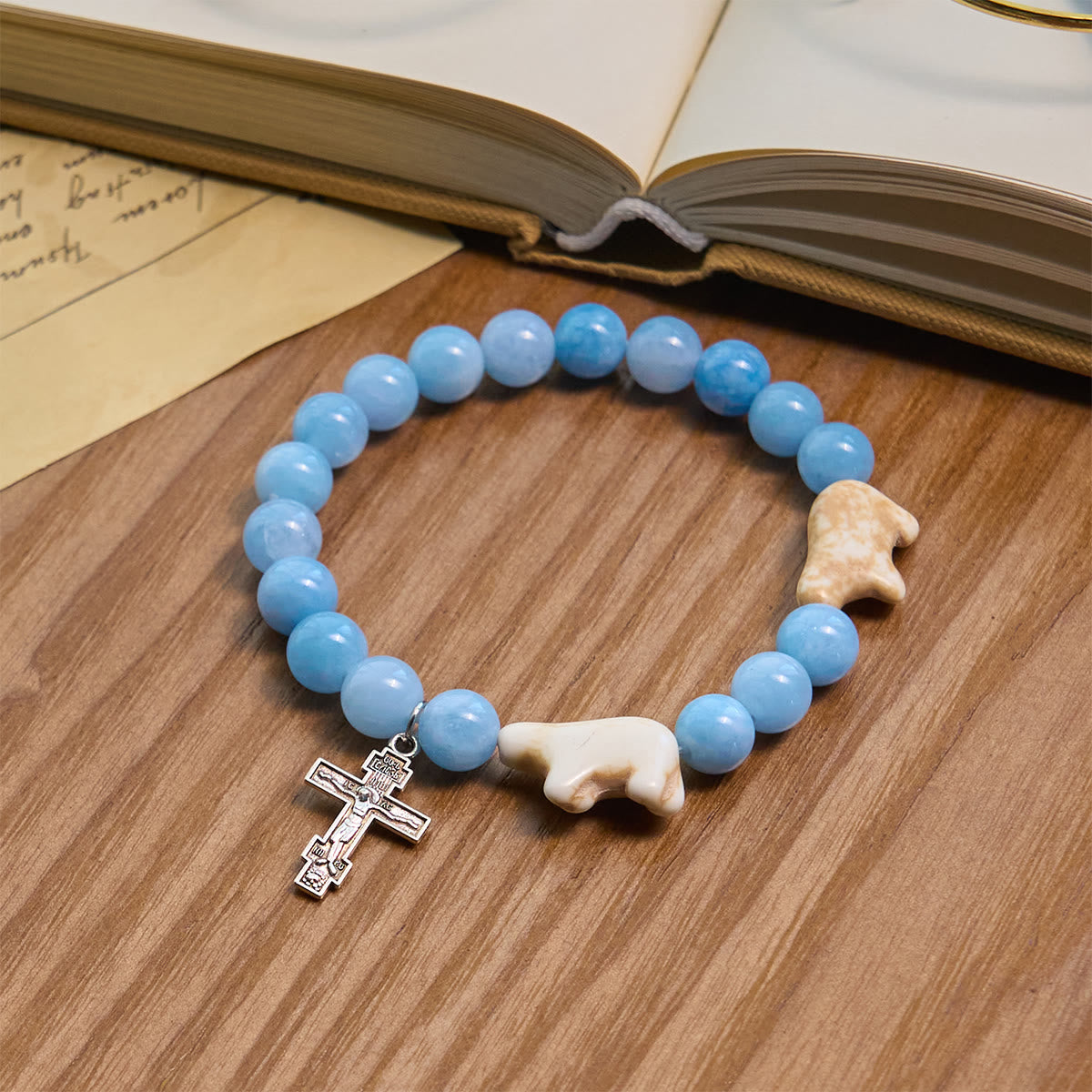 Pulsera de cruz hecha a mano de oso polar con cuentas azules: Salvemos a nuestros osos polares