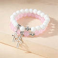 Conjunto de pulseras de cuentas con dijes de cruz bicolor: un símbolo de fe en cada uso