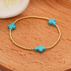 Pulsera de turquesas de diseño original con cuentas de cruz